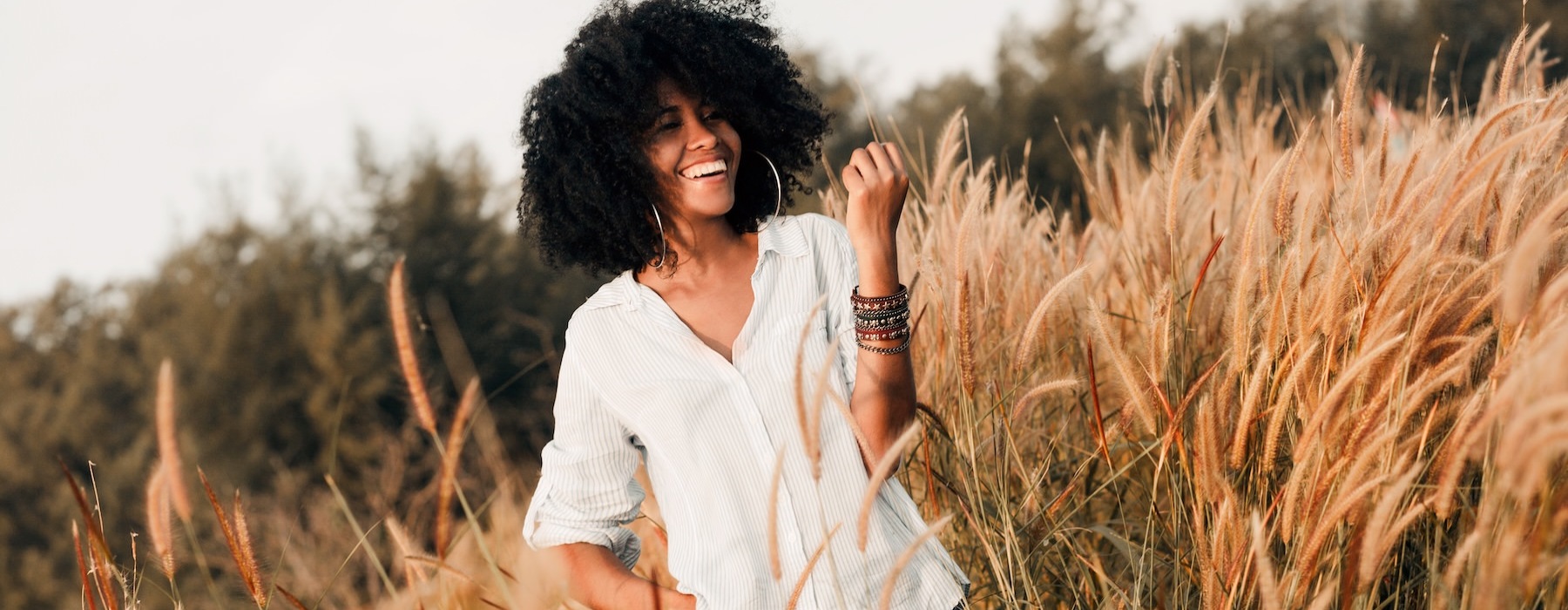a person standing in a field of tall grass