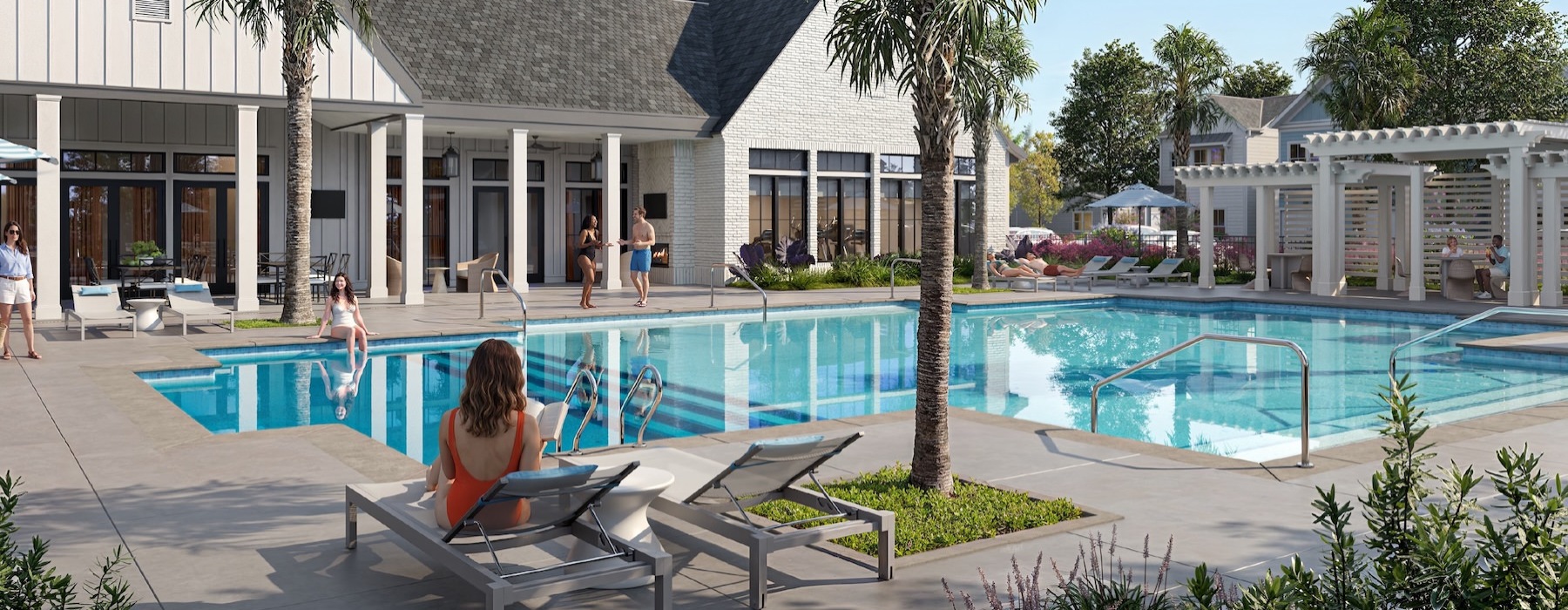 a person sitting on a bench by a pool