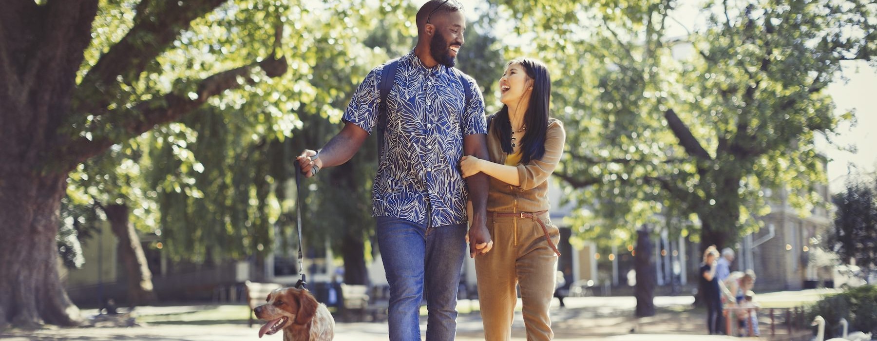 a man and woman walking a dog