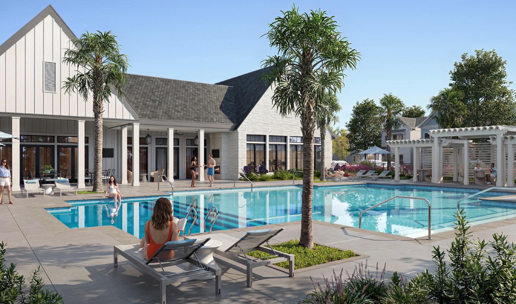 a person sitting on a bench by a pool